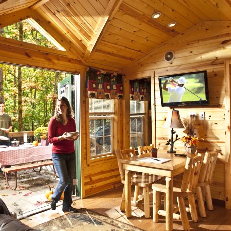 woman walking into large cabin with kitchen area