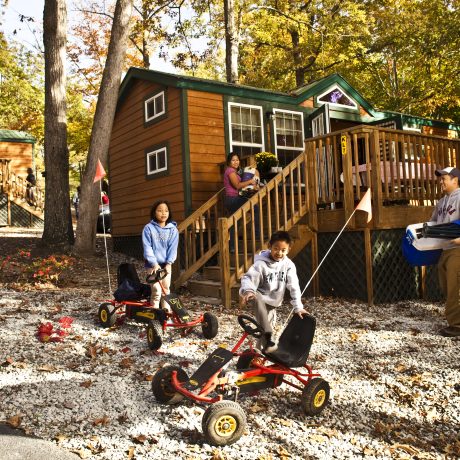 kids playing in front of cabin