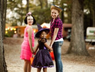 kids in halloween costumes smiling at camera