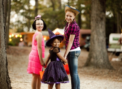 kids in halloween costumes smiling at camera