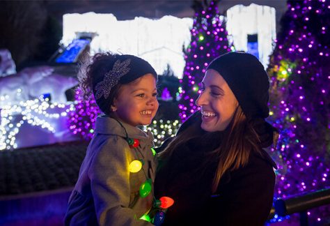 mother and child smiling near christmas decorations