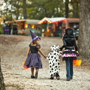 kids in halloween costumes walking away from camera