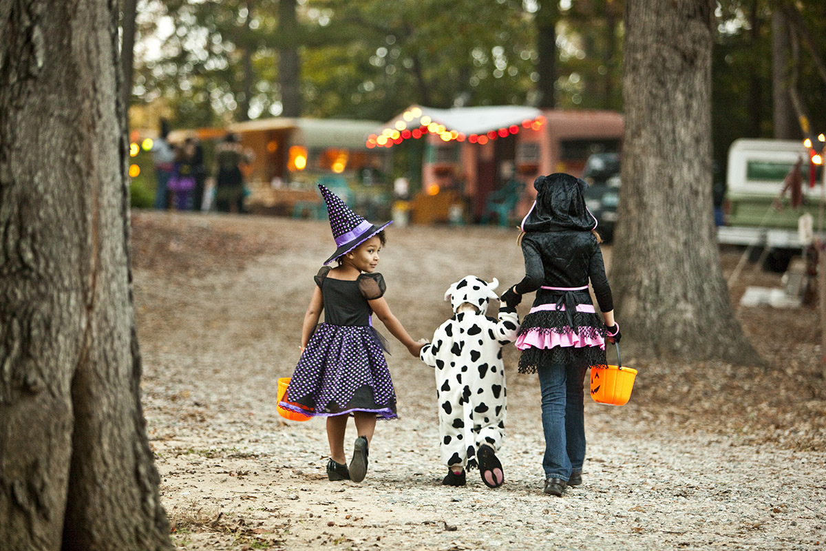 kids in halloween costumes walking away from camera