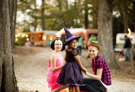 kids in halloween costumes smiling at camera