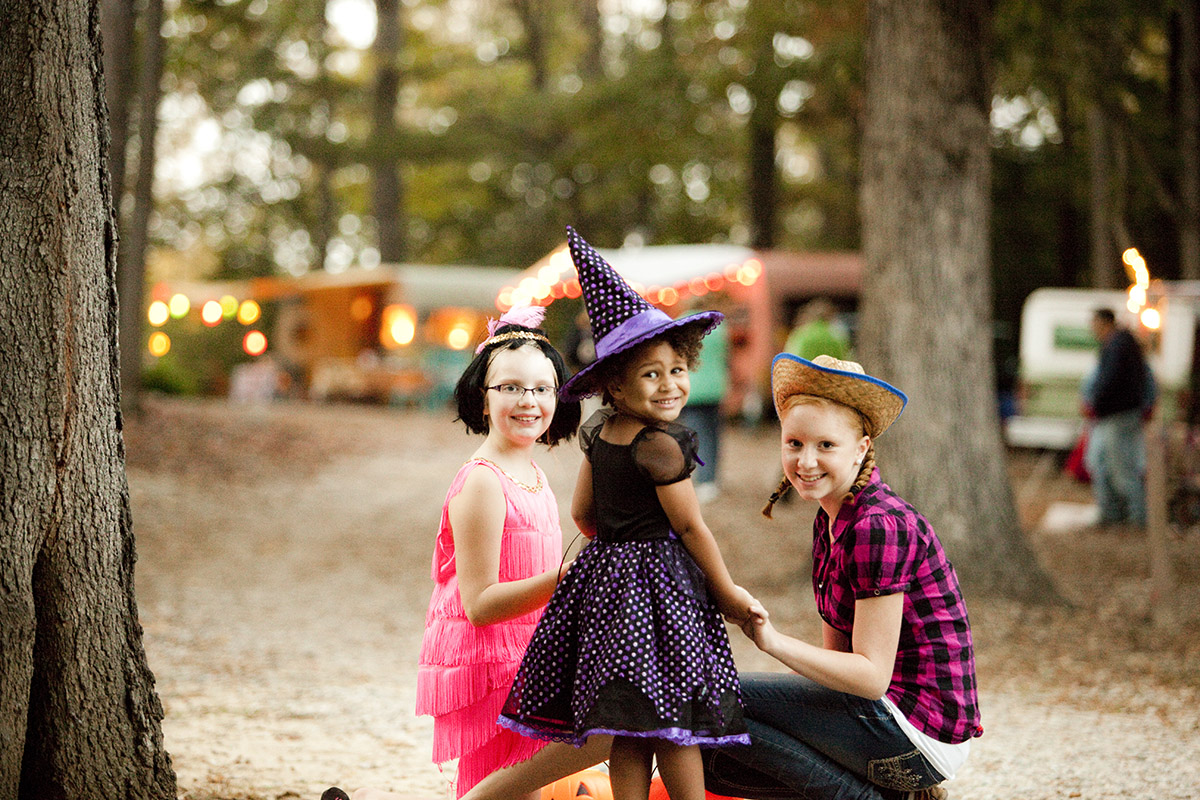 kids in halloween costumes smiling at camera